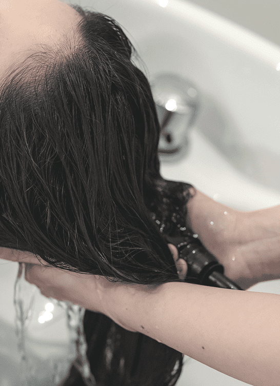 女性の髪を洗っている画像